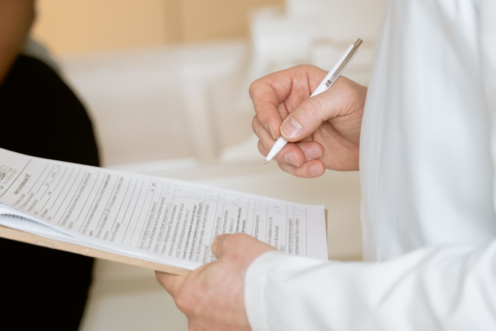 A clinician reading through a printed report.