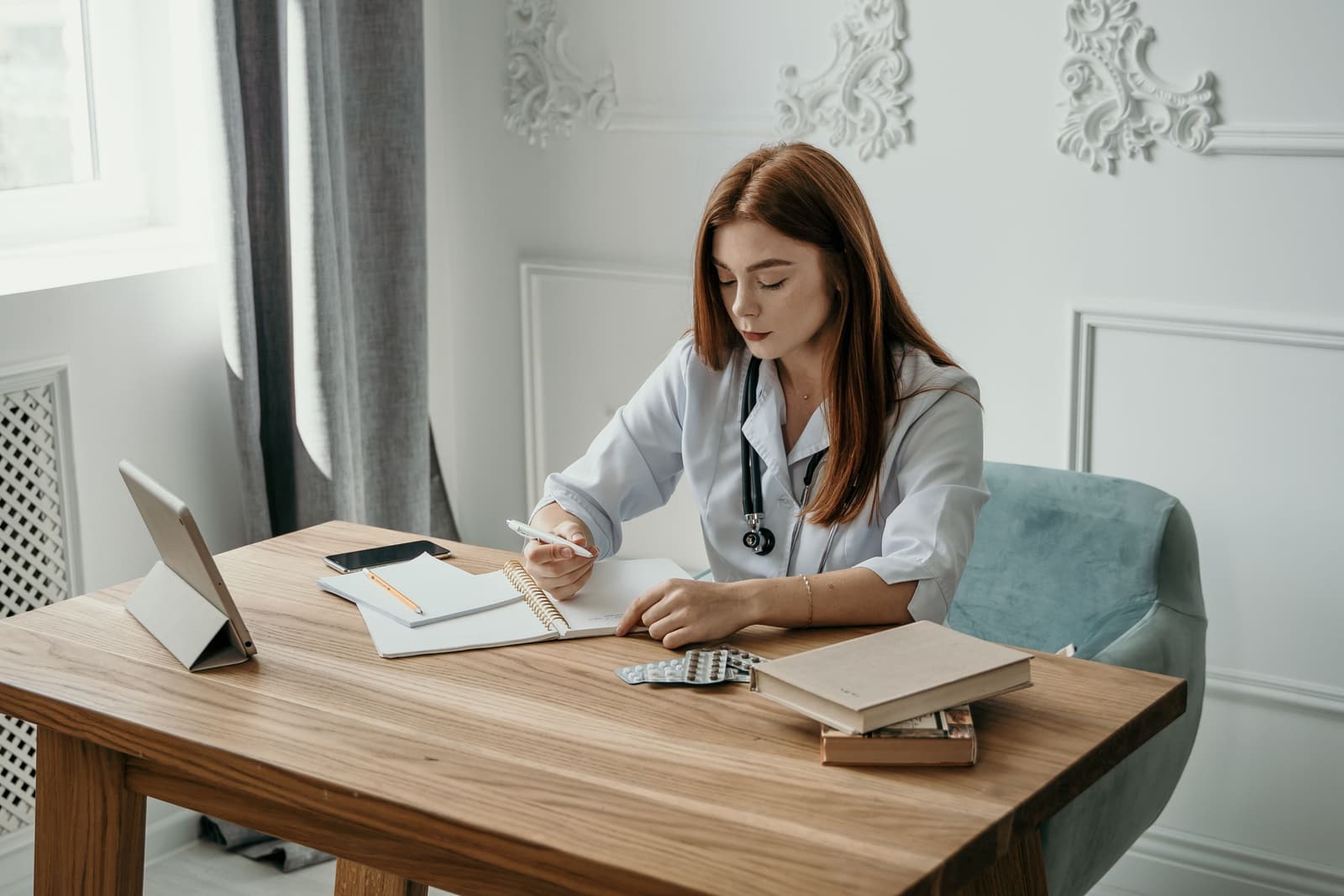 Close on a desk at Coppice Row, with notes being written up after an appointment.