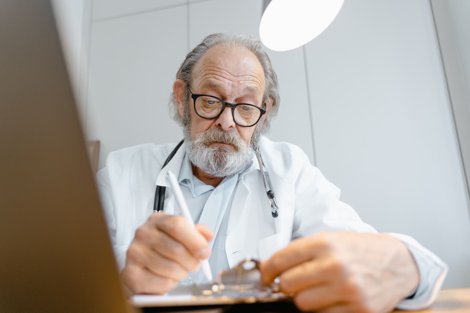 A clinician writing up notes in one of the Coppice Row consulting rooms.