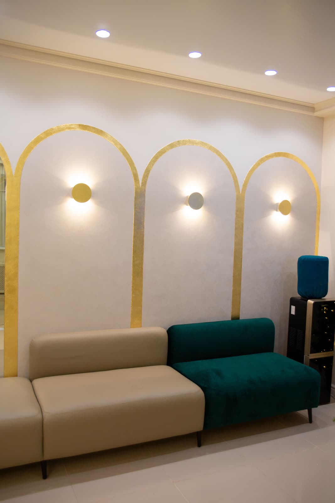 The arrival lounge at Larkmoor Fieldgate, with lit arches above the seating.