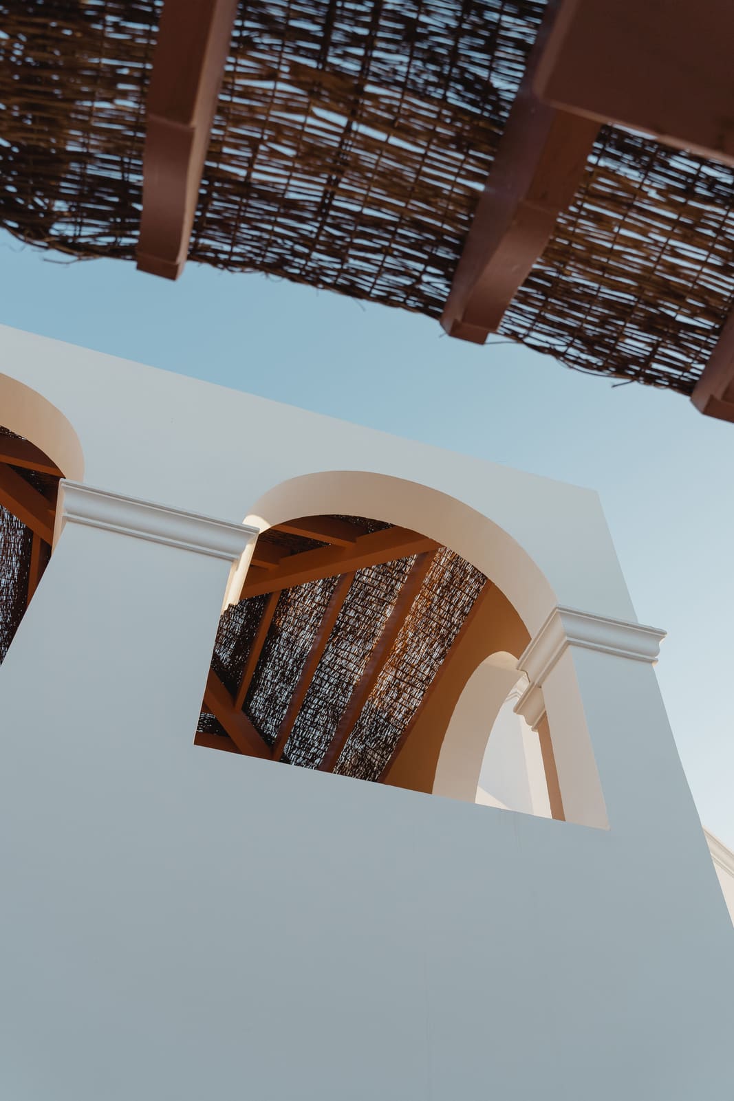 White arches and a lattice roof seen from below.