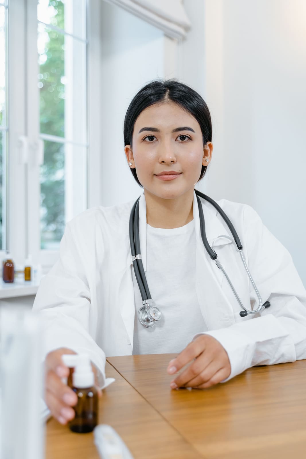 A clinician at her desk at the start of a preventative health assessment.
