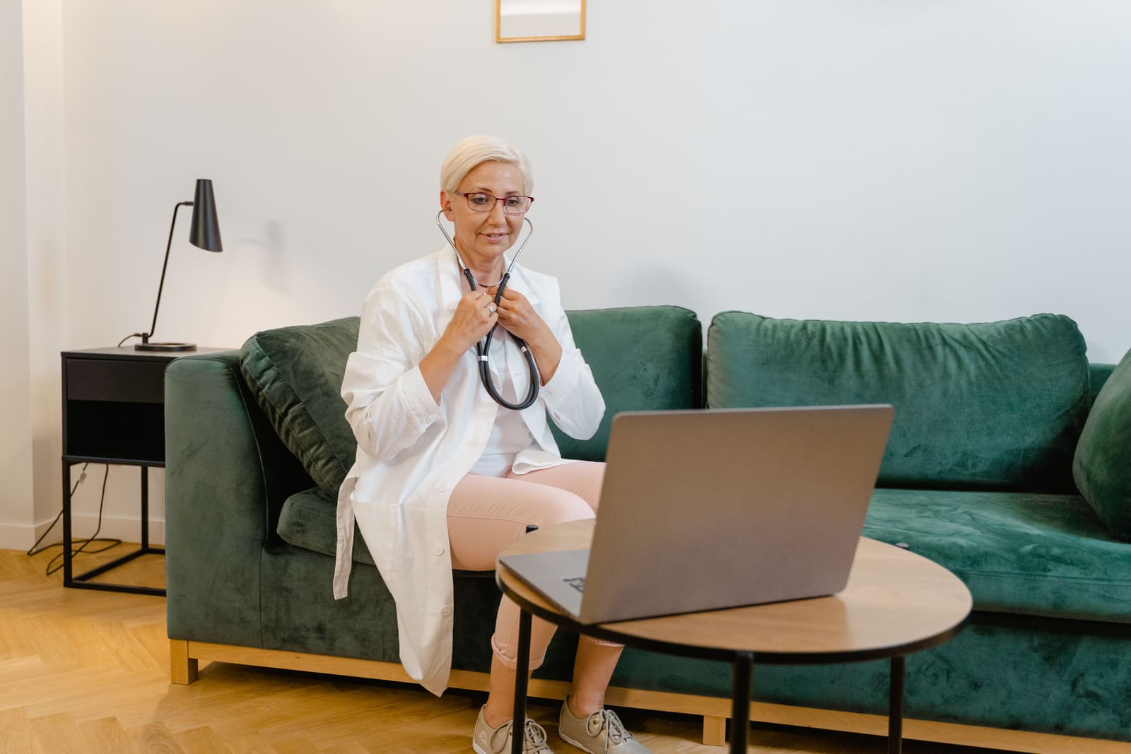 A clinician holding a video appointment from a consulting room.