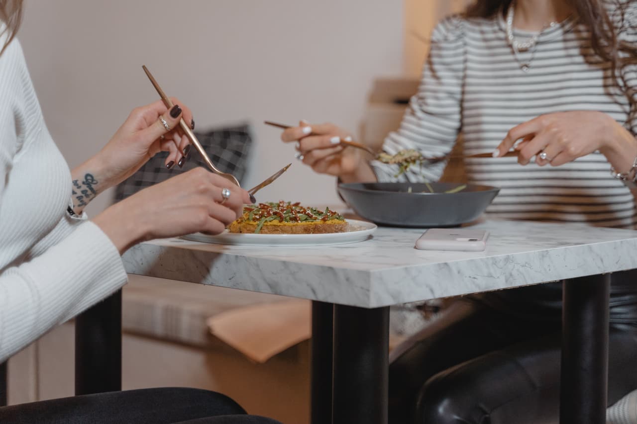 Two people sharing a meal at a table.