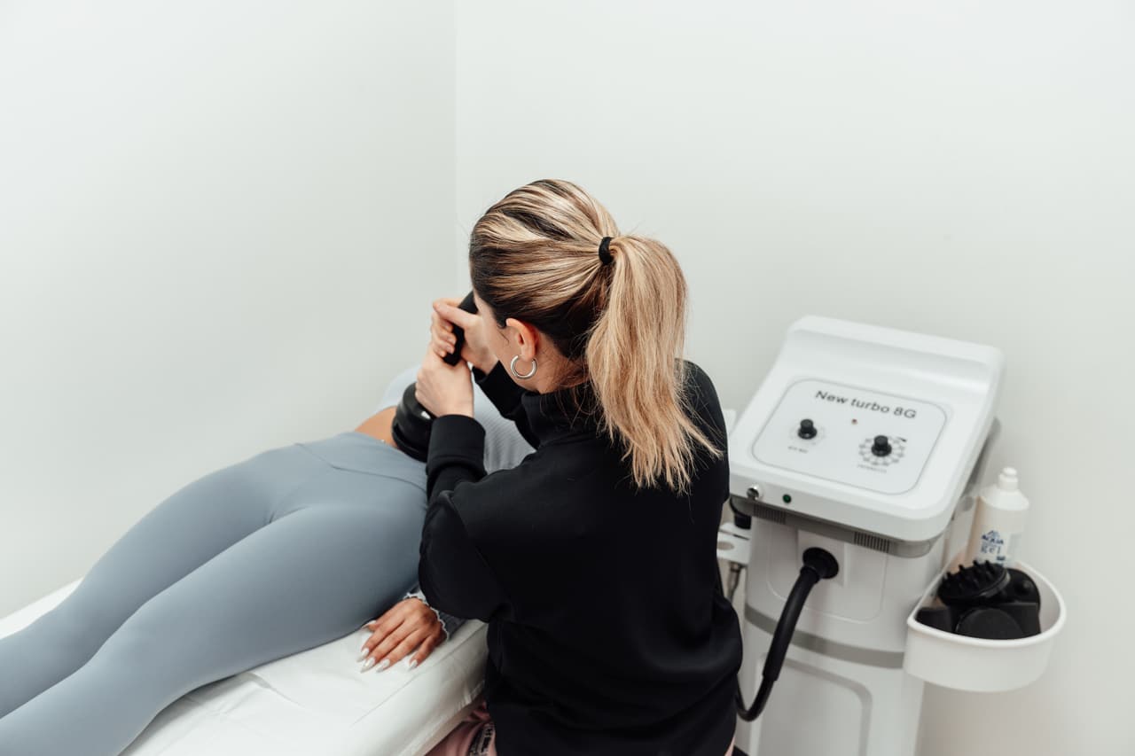A physiotherapist working with a patient on a treatment couch.