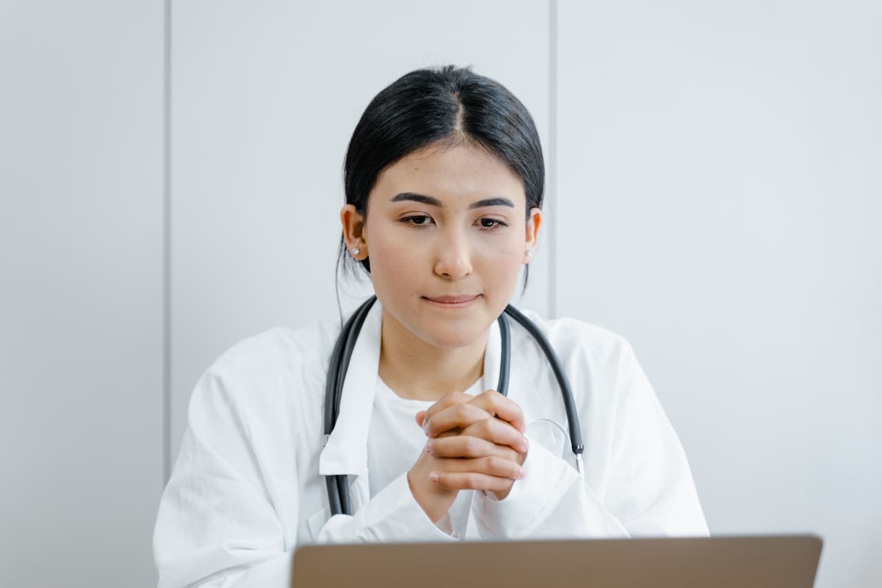 A clinician mid-consultation during a preventative health assessment.
