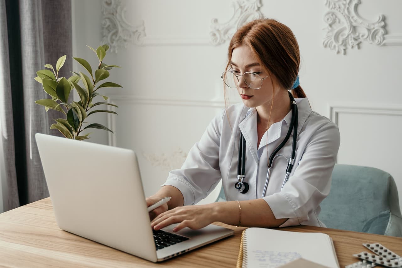 A clinician working through a travel health consultation at her desk.